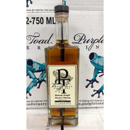 Purple Toad small batch Kentucky bourbon bottle with case packaging behind it.