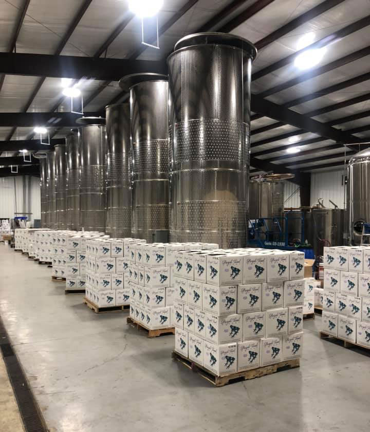 Stainless steel wine tanks and Purple Toad cases inside the Paducah production facility