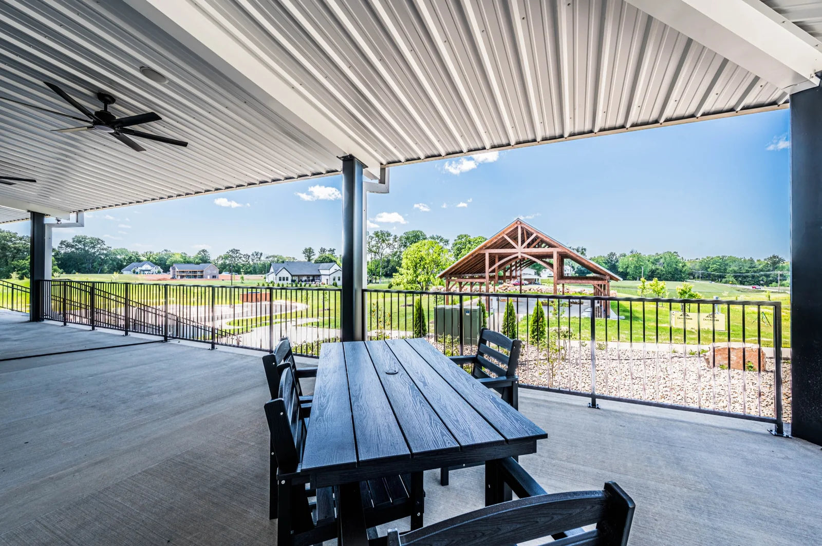 Covered patio seating overlooking the outdoor pavilion in Bowling Green