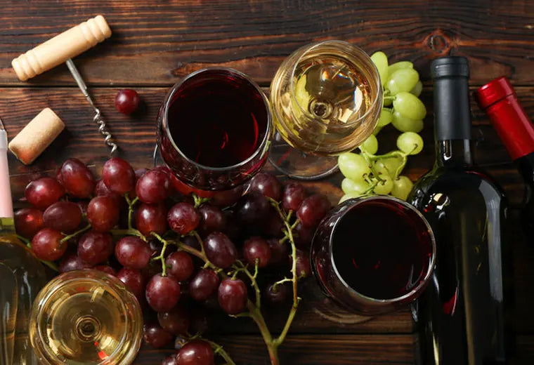 Red and white wine pours with grapes and bottles